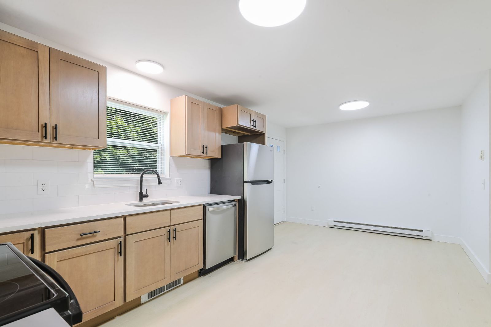 Kitchen with a window over the sink and wood cabinets