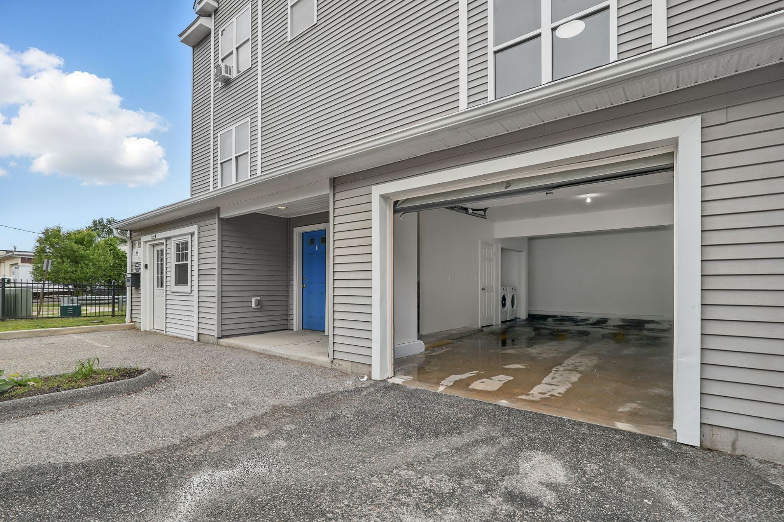 Open garage door at the front of a townhome