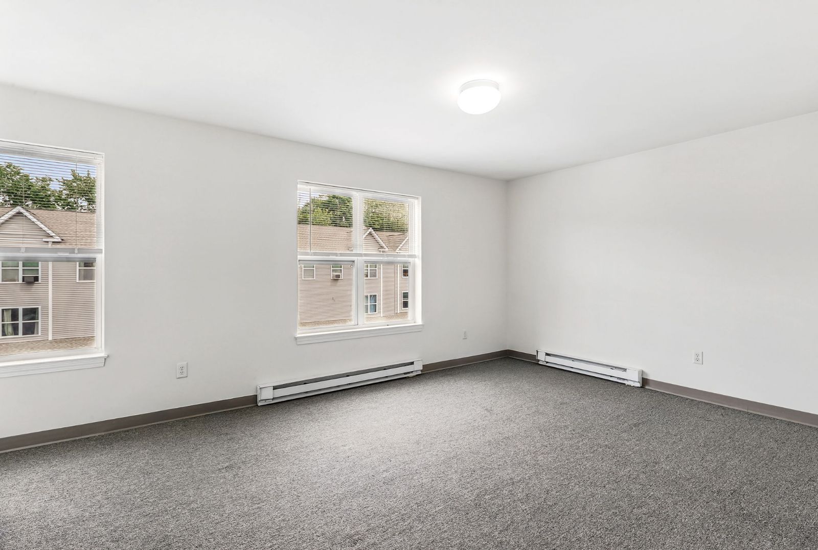 Carpeted bedroom with two windows